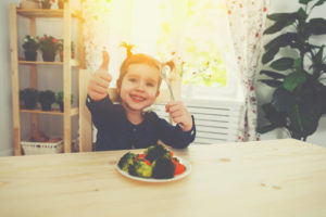 Excited little girl thumbs up to vegetables - Picky Eaters